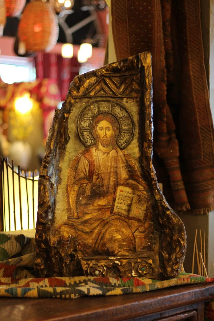 Icon of Christ holding an open book, painted on a carved wood stump