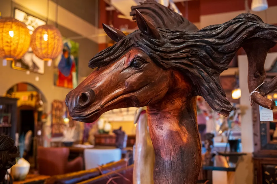 Carved wooden horse head sculpture in The Rustic Gallery showroom